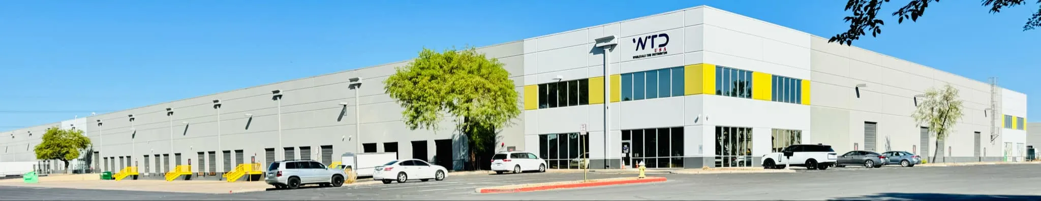 Wide view of the WTD USA warehouse with loading docks along the building